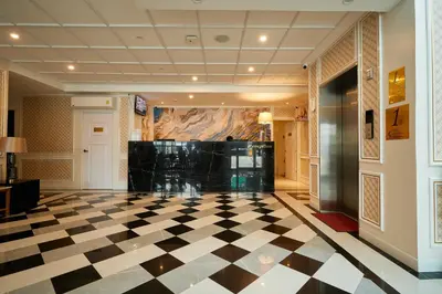 a lobby with a black and white checkered floor at Rose Apple Hotel in Bangkok