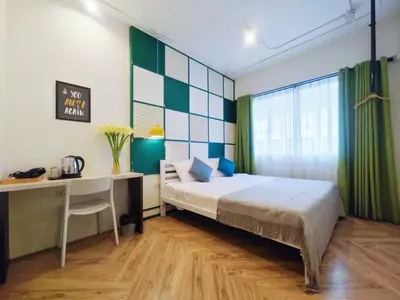 a bedroom with a bed and a desk and a computer at Ostay Asoke Bangkok in Makkasan