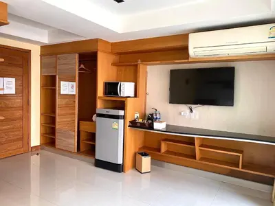 a kitchen with a refrigerator and a tv on a wall at L18 residence แอลสิบแปด เรสซิเดนซ์ in Ban Zong Katiam