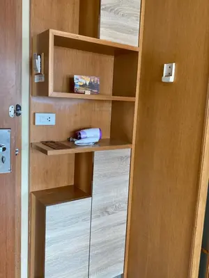 a book shelf with a phone in a room at L18 residence แอลสิบแปด เรสซิเดนซ์ in Ban Zong Katiam