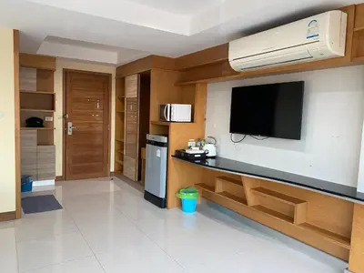 a living room with a flat screen tv on a wall at L18 residence แอลสิบแปด เรสซิเดนซ์ in Ban Zong Katiam