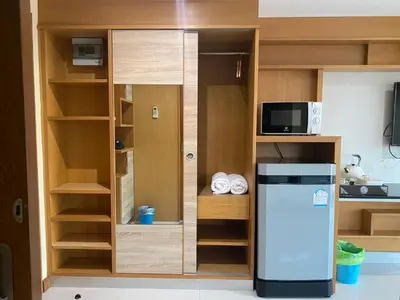 a small kitchen with a refrigerator and shelves at L18 residence แอลสิบแปด เรสซิเดนซ์ in Ban Zong Katiam