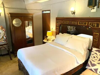 a bedroom with a large bed with a wooden headboard at Cafe ice resident in Yan Nawa