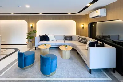 a living room with a couch and tables at Wellness Stay & Hotel Sukhumvit 107 in Bangna