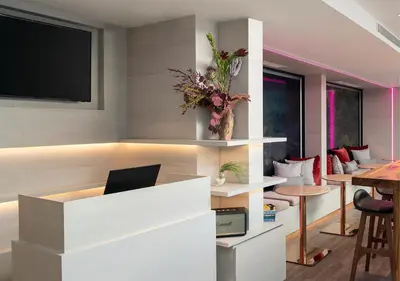 a living room with a desk with a laptop on it at Jono Bangkok Asok Hotel in Bangkok
