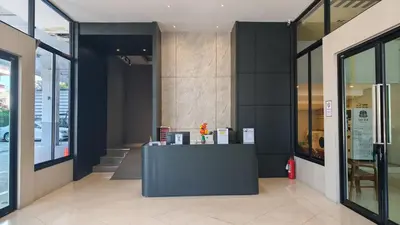 a lobby of a building with a reception desk at C Hotel Bangna in Bangkok