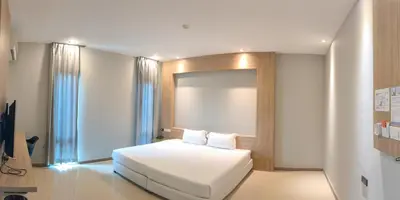 a bedroom with a white bed and a window at C Hotel Bangna in Bangkok