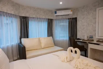 a hotel room with two swans sitting on a bed at Masa Hotel فندق الماسة شارع العرب in Bangkok