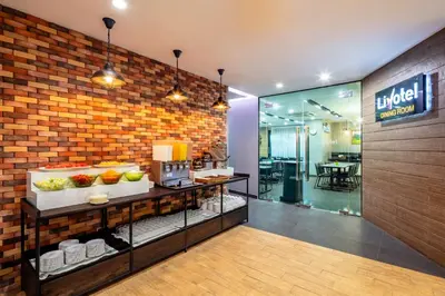 a lobby of a hotel with a counter with food at Livotel Hotel Lat Phrao Bangkok in Bangkok