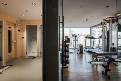 a gym with treadmills and machines in a building at VOQUE Hotel & Serviced Residence Sukhumvit 51 in Bangkok
