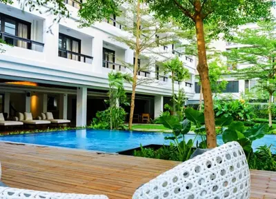 a resort with a swimming pool in front of a building at UMA Residence in Bangkok