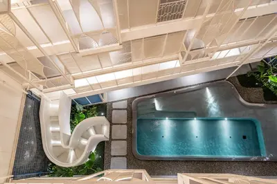 a jacuzzi tub in a building with plants at YANH Ratchawat Hotel in Bangkok