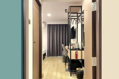 a hotel room with a desk and a room at City Park Hotel Bangkok Pratunam by PCL in Bangkok