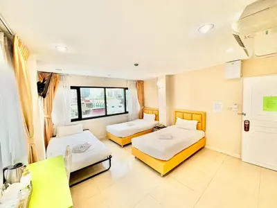 a hospital room with two beds and a window at ABCYQ Hotel in Bangkok