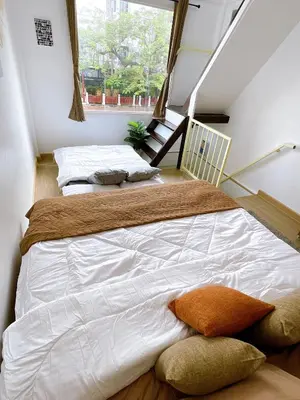 a large white bed in a room with a window at Lively and cozy canal house ,Entire house in Bangkok