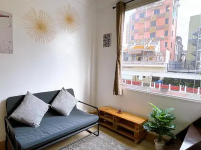 a living room with a couch and a window at Lively and cozy canal house ,Entire house in Bangkok