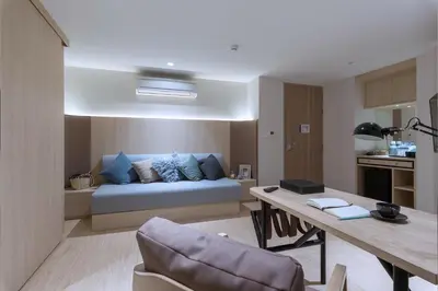 a living room with a couch and a table at Bella B Hotel in Nonthaburi