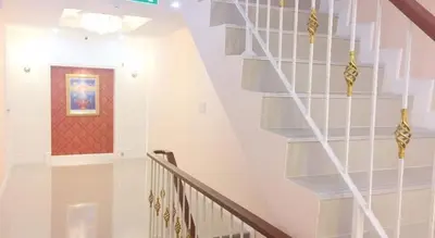 a white staircase with a red door at Sabai Dee Minitel in Dusit