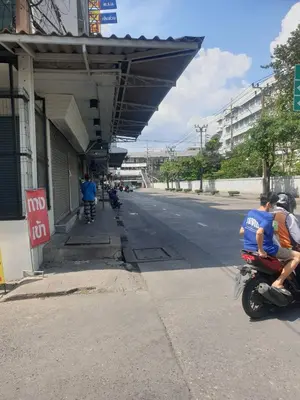 a group of people riding on a motorcycle at a gas station at BEN HOUSE in Bangkok