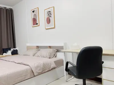 a bedroom with a bed and a desk and a chair at 32Sqm 1000x500wifi workplace long stay in Amphoe Phra Khanong