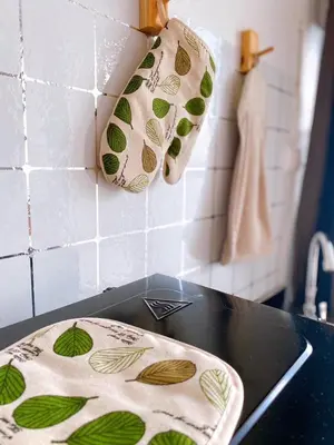 a kitchen counter with two towels on a stove at 32Sqm 1000x500wifi workplace long stay in Amphoe Phra Khanong