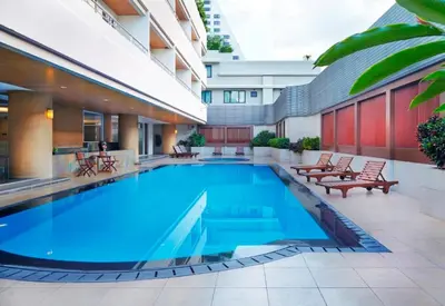 a swimming pool in the middle of a building at S.M. GRANDE RESIDENCE in Bangkok