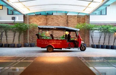 a small red golf cart parked in a building at S.M. GRANDE RESIDENCE in Bangkok