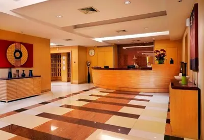 a lobby of a hotel with a checkered floor at S.M. GRANDE RESIDENCE in Bangkok
