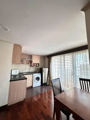 a kitchen and dining room with a table and a dining room gmaxwell gmaxwell gmaxwell gmaxwell at S.M. GRANDE RESIDENCE in Bangkok