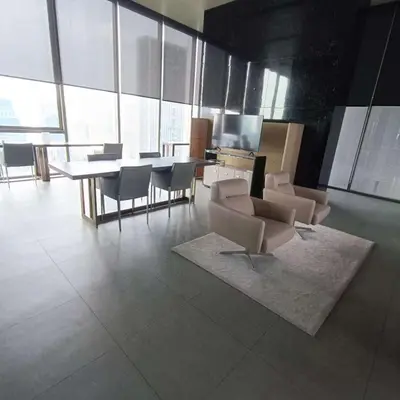 a living room with chairs and a table and a television at Sathon Luxury High-rise Apartment City View KingPower ,IconSiam ,BNH,Silom in Bangkok
