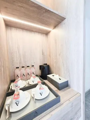 a table with three plates and a box at Ascella Bangkok Hotel in Makkasan