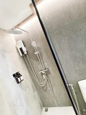 a shower in a bathroom with a glass door at Ascella Bangkok Hotel in Makkasan