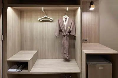 a suit on a hanger in a closet at Grace At Five by Grace Hotel Bangkok in Bangkok