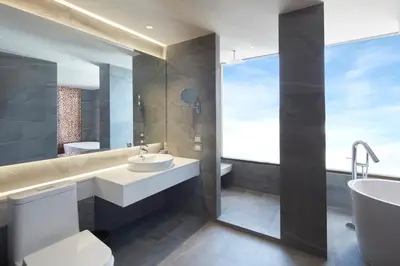 a bathroom with a sink and a tub and a toilet at Grace At Five by Grace Hotel Bangkok in Bangkok