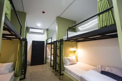 a room with three bunk beds in a hostel at All day hostel at BTS Bang Chak in Bangkok