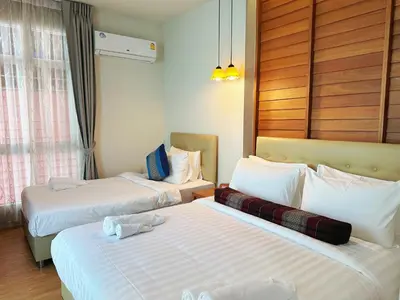 two beds in a hotel room with white sheets at CozyHouse near MRT QSCC Convention Center 4BR 10ppl in Bangkok