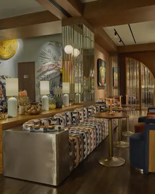 a lobby with a waiting area with tables and chairs at Public House Bangkok, a Member of Design Hotels in Bangkok
