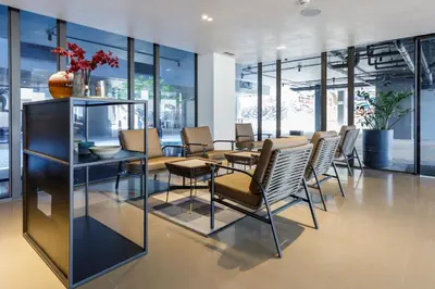 a dining room with a table and chairs at Benjarong Hotel Bangkok Ratchada in Bangkok