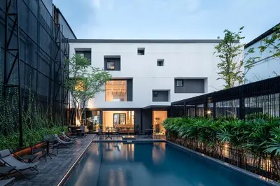 a swimming pool in the middle of a building at Lilit Bang Lumphu Hotel in Bangkok