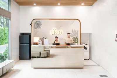 a reception area of a restaurant with a mirror at The Rich Residence Sukhumvit Nana in Bangkok