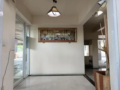 a hallway with a cross and a painting on the wall at Grandview Condominia in Bangkok