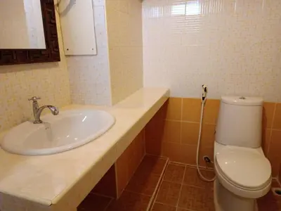 a bathroom with a sink and a toilet at Grandview Condominia in Bangkok
