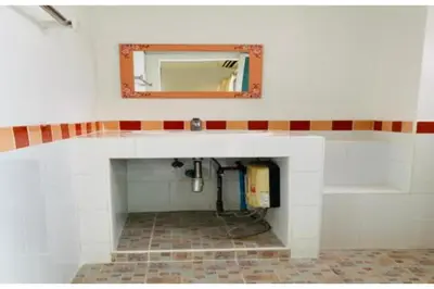 a bathroom with a sink and a mirror on the wall at Grandview Place in Bangkok