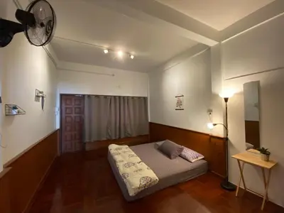 a bedroom with a bed and a ceiling fan at Freedom8 in Khlong San