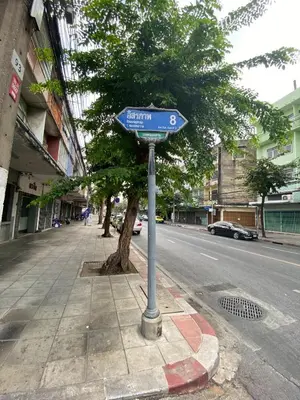 a blue street sign on the side of a street at Freedom8 in Khlong San
