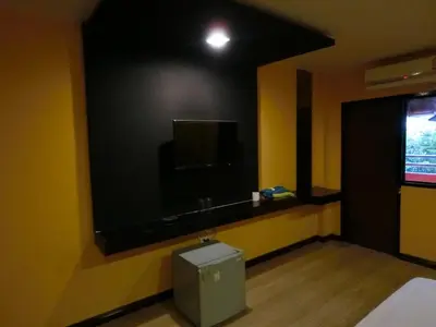a room with a flat screen tv on a wall at NewYork Suite Hotel in Ban Ko