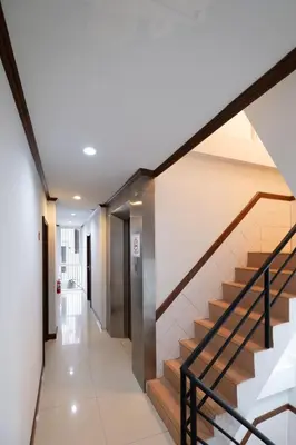 a hallway with stairs in a house at Amber Inn in Bangkok