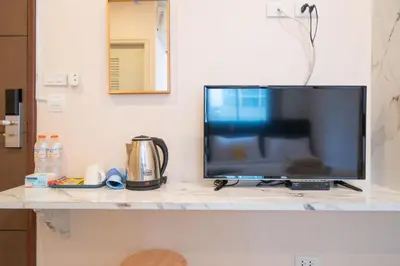 a flat screen tv sitting on top of a counter at Amber Inn in Bangkok