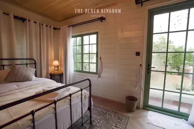 a bedroom with a bed and a large window at The Black Kingdom - เดอะ แบล็ค คิงดอม in Bangkok