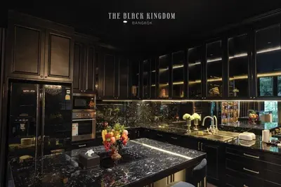 a kitchen with black cabinets and a granite counter top at The Black Kingdom - เดอะ แบล็ค คิงดอม in Bangkok